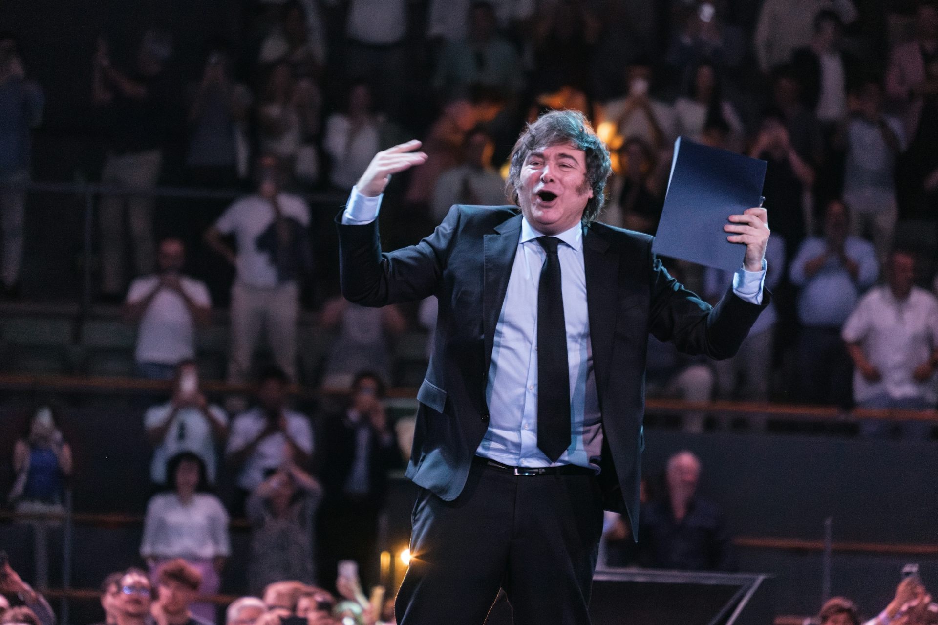 Javier Milei addressing the audience from a stage at a conference in Madrid, Spain.