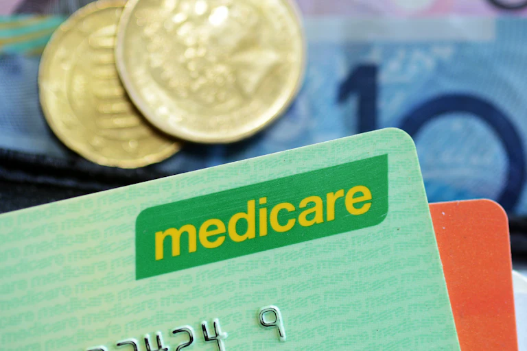 Medicare card with Australian bank notes and coins