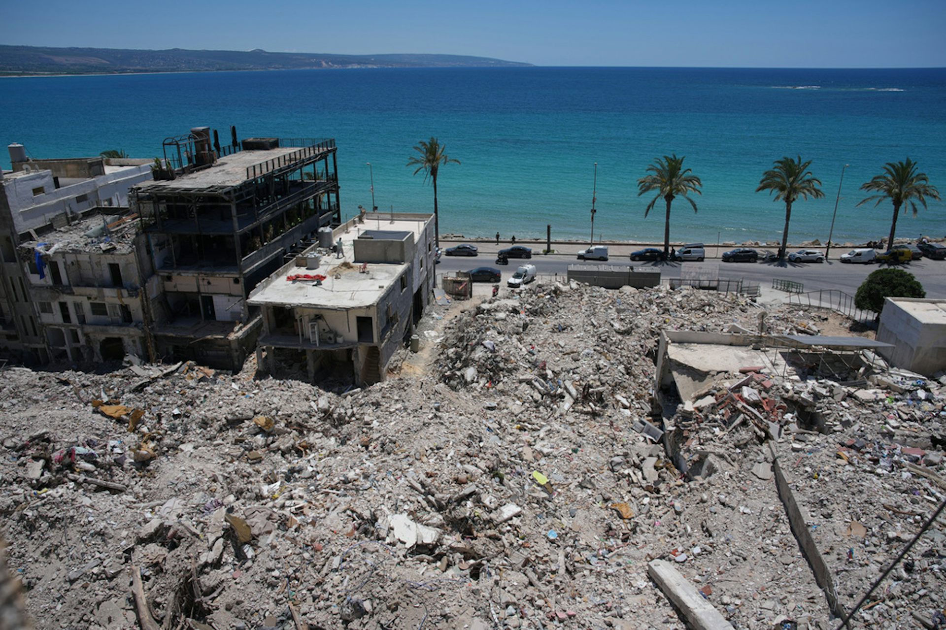 Extensive building rubble with the ocean in background.
