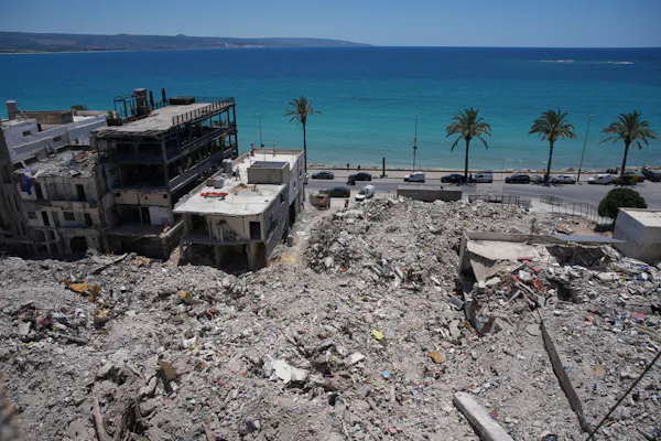 Extensive building rubble with the ocean in background.