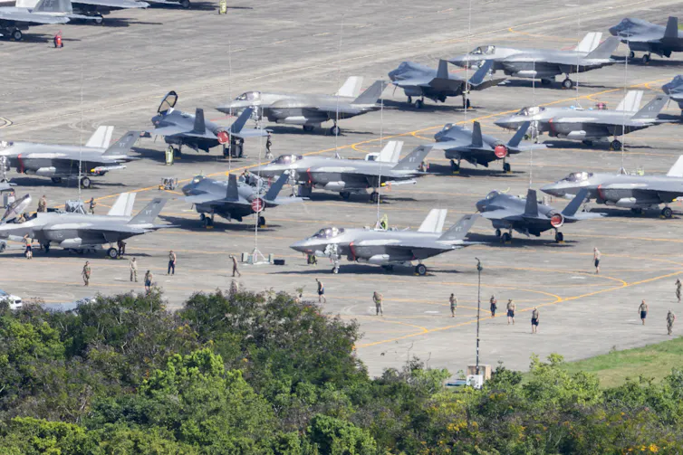 Fighter jets on an airport tarmac.