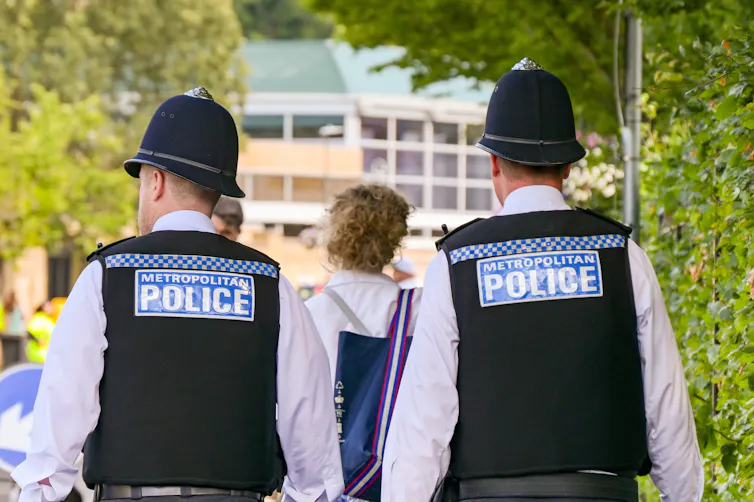 View from behind of two Metropolitan Police officers