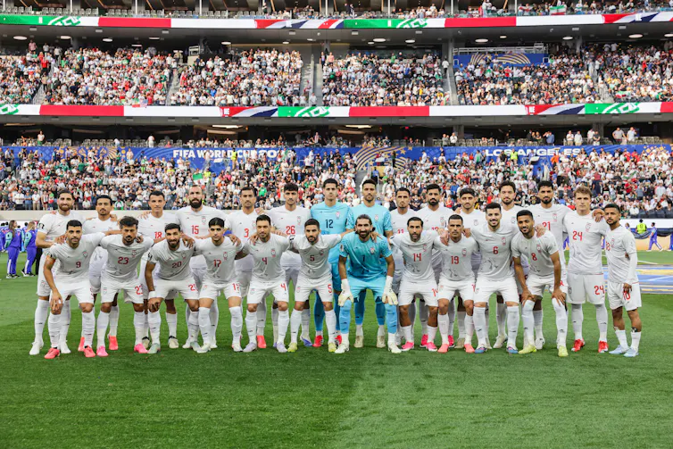 Football team pose in white.