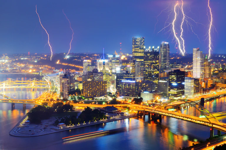 Lightning in the sky above a city at night.