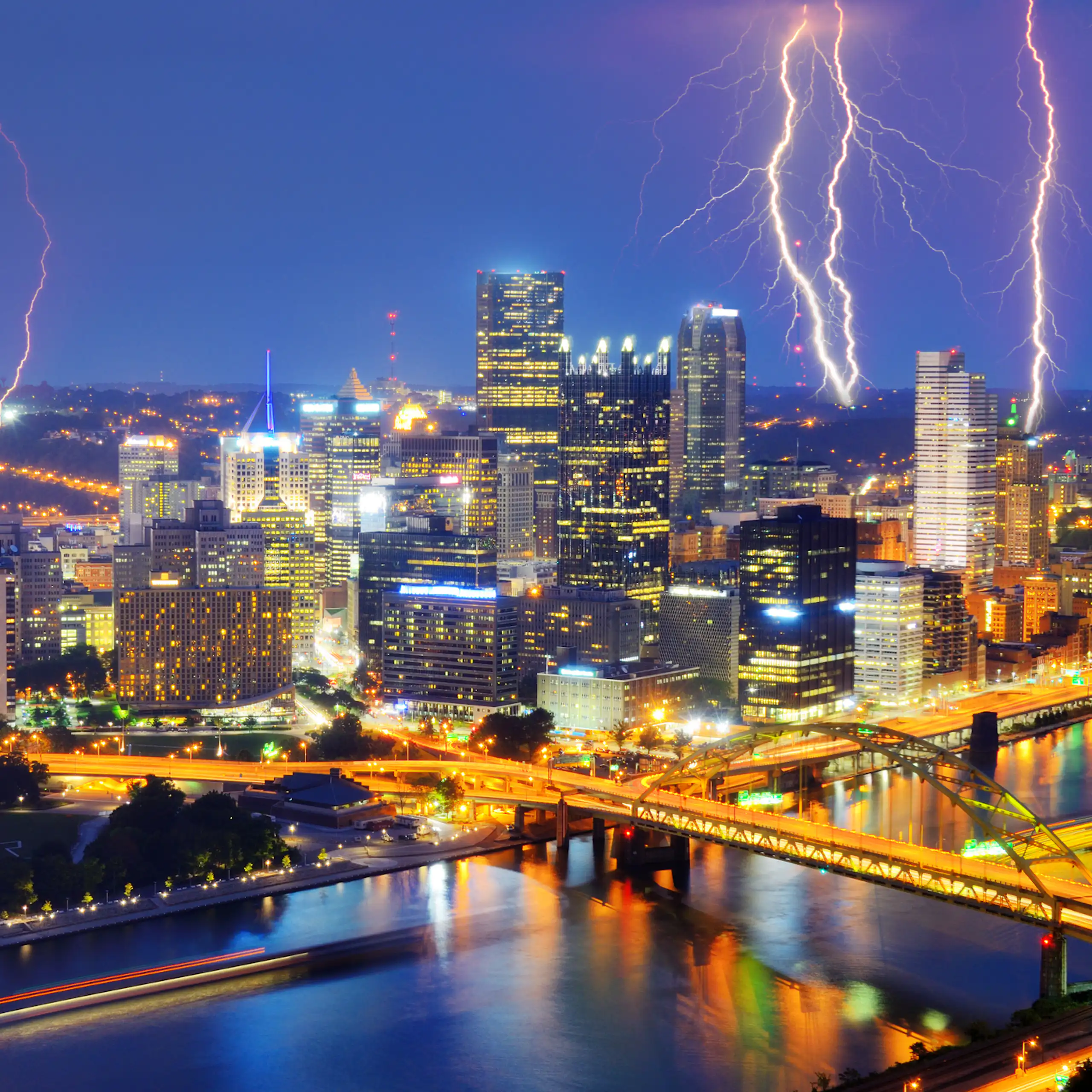 Lightning in the sky above a city at night.