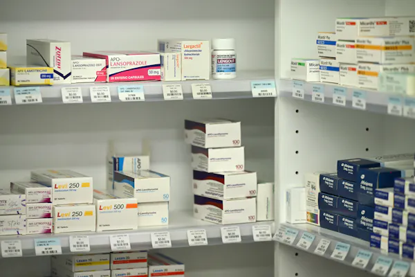 Medicine boxes on pharmacy shelves