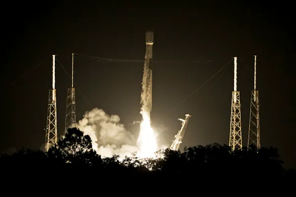 A rocket takes off against a dark sky.