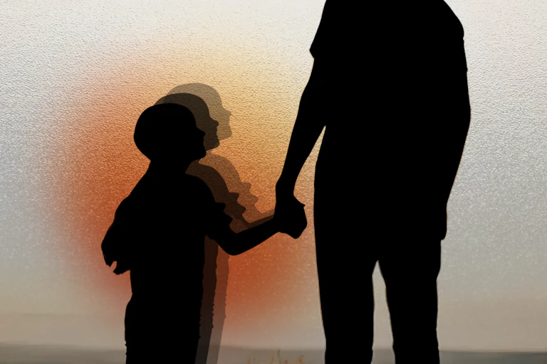 A silhouette of a child holding an adult's hand