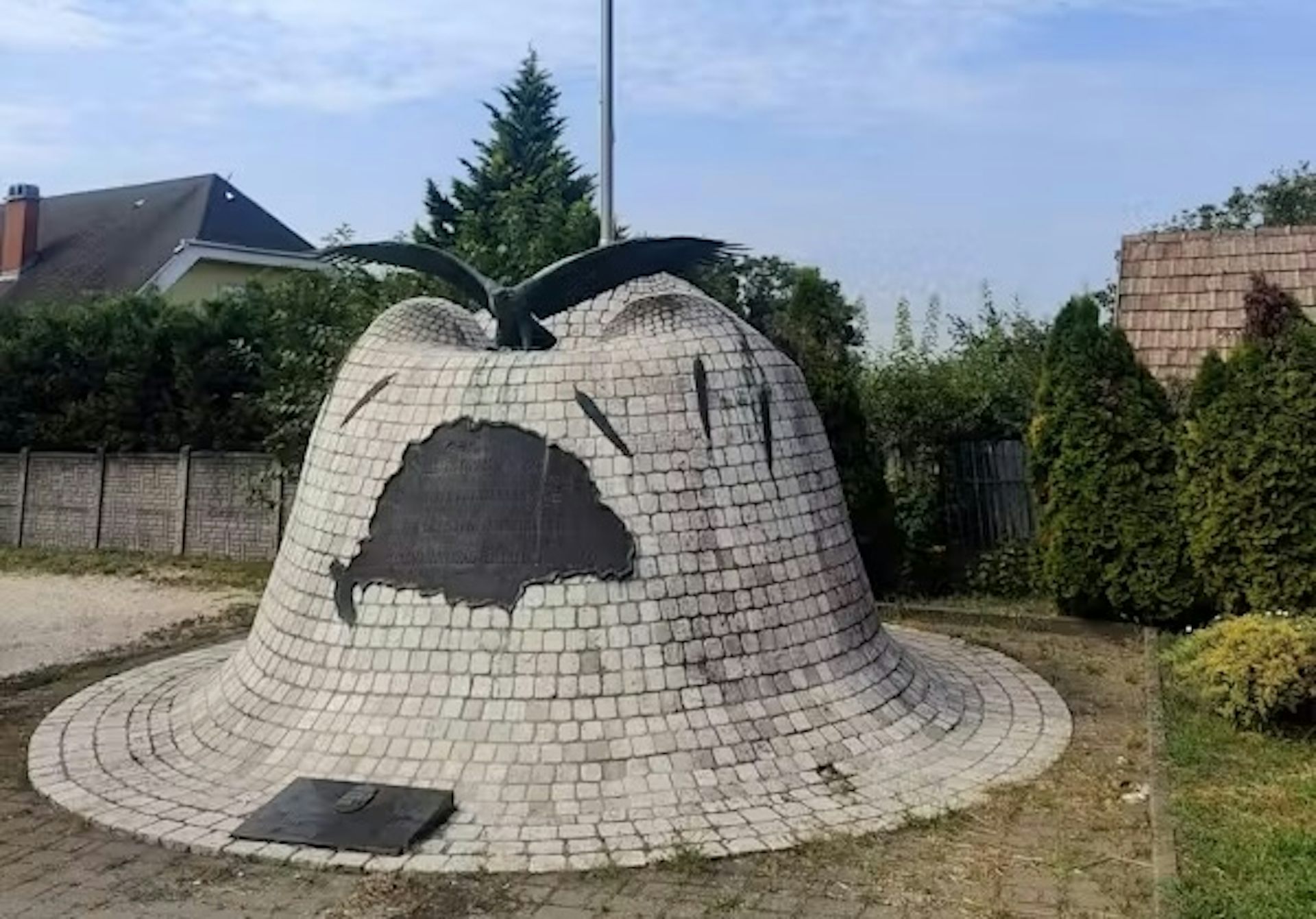 A stone memorial in the shape of a helmet.
