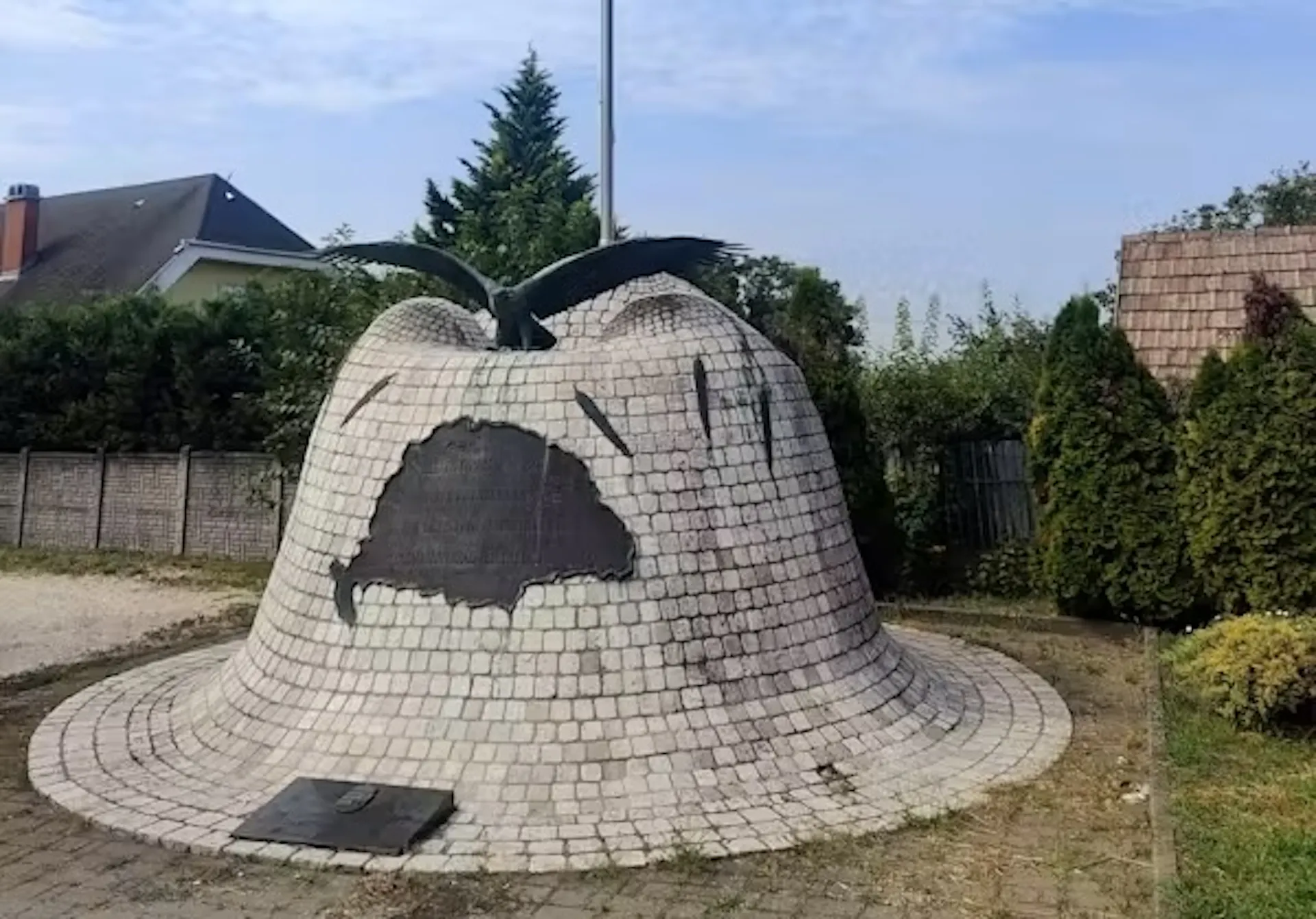A stone memorial in the shape of a helmet.