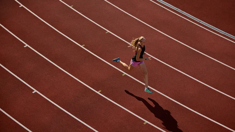 Woman running on a track.