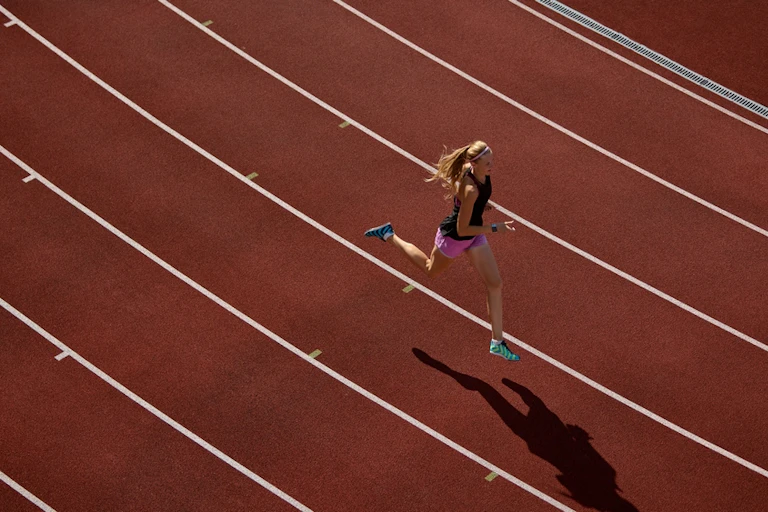 Woman running on a track.