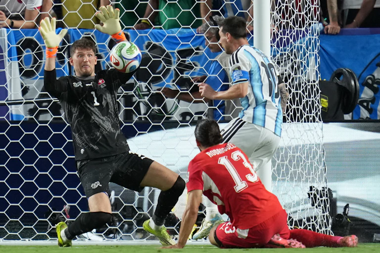 Switzerland goalkeeper Gregor Kobel makes a save against Argentina's Lionel Messi during the World Cup quarter-final.