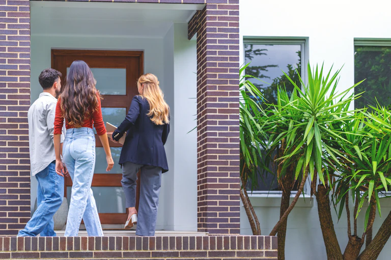 A real estate agent showing a couple a new house.
