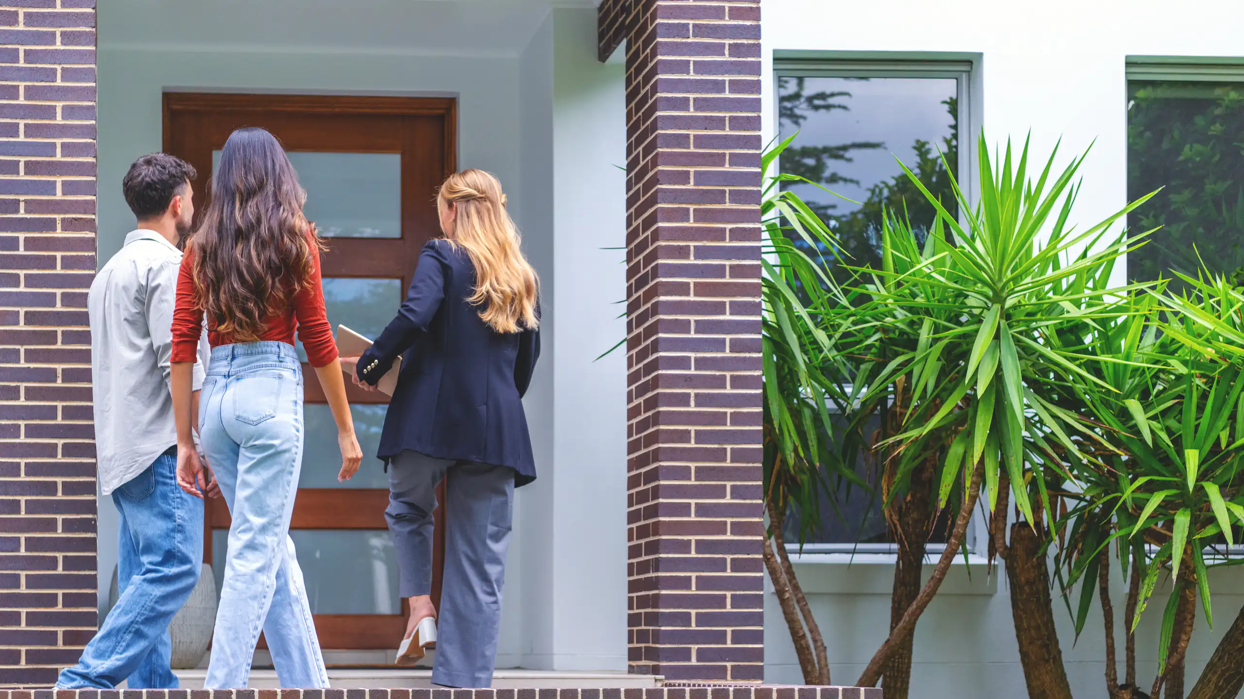 A real estate agent showing a couple a new house.