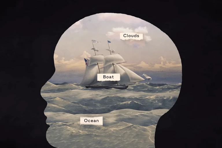 A silhouette of a head outlining an image of a ship on the sea with labels reading 'Clouds', 'Boat' and 'Ocean'