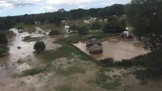 An area viewed from the sky with huts and farmland under water