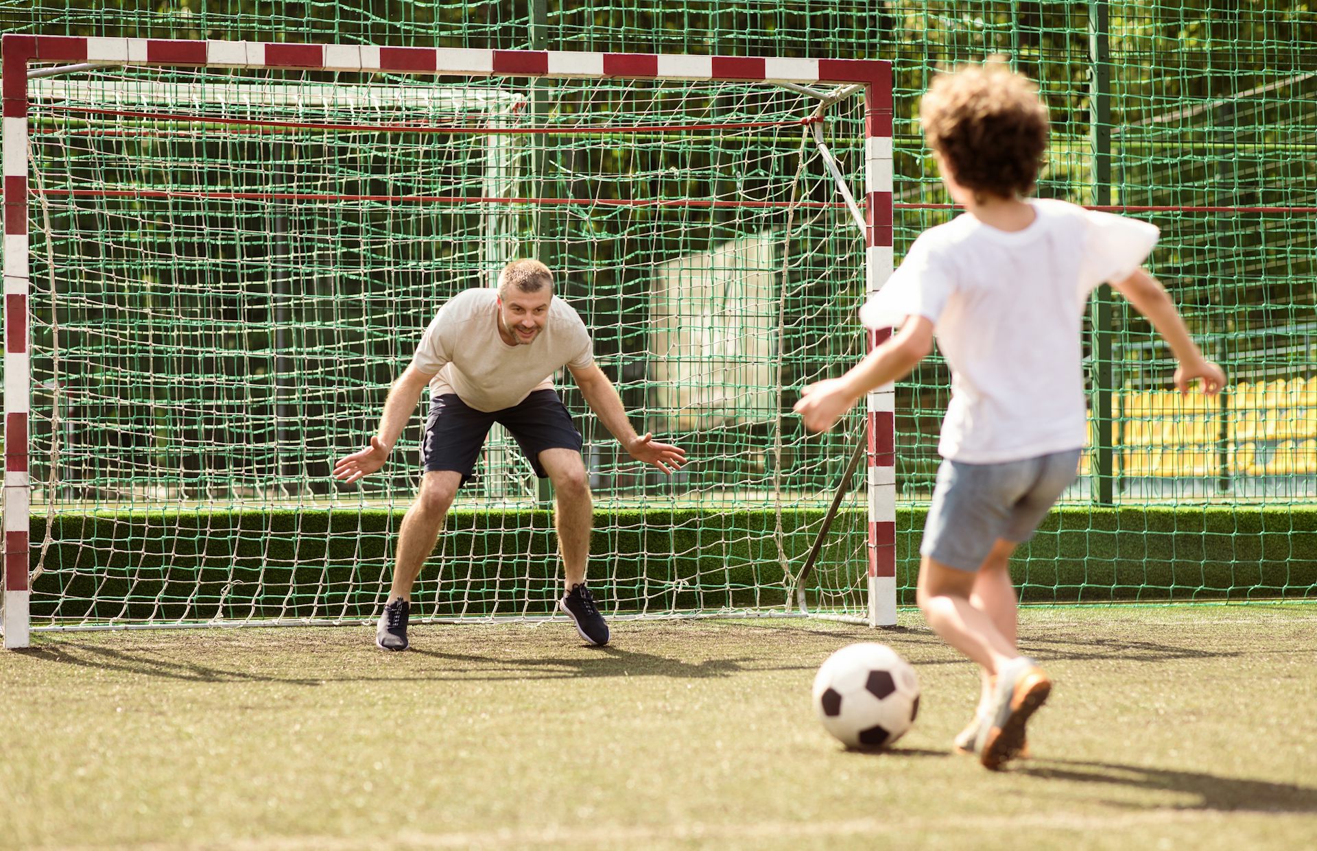 A father playing football with his son