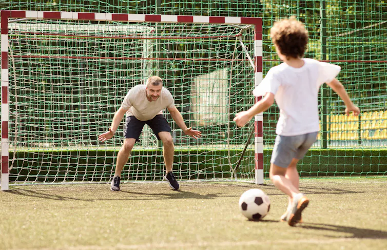 A father playing football with his son