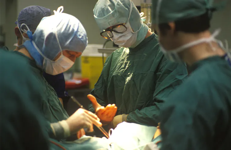 Surgeons performing heart surgery