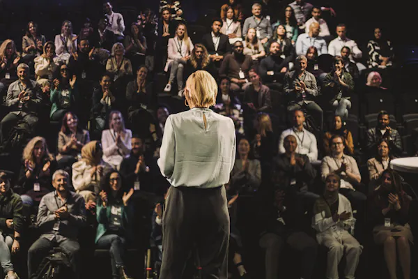 View from behind of a woman presenting to an audience