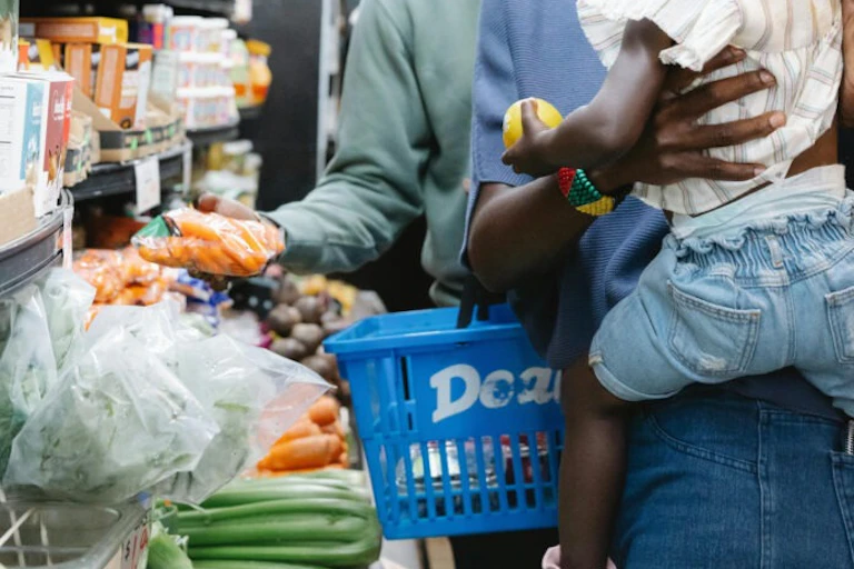 Adult holding a child in a supermarket