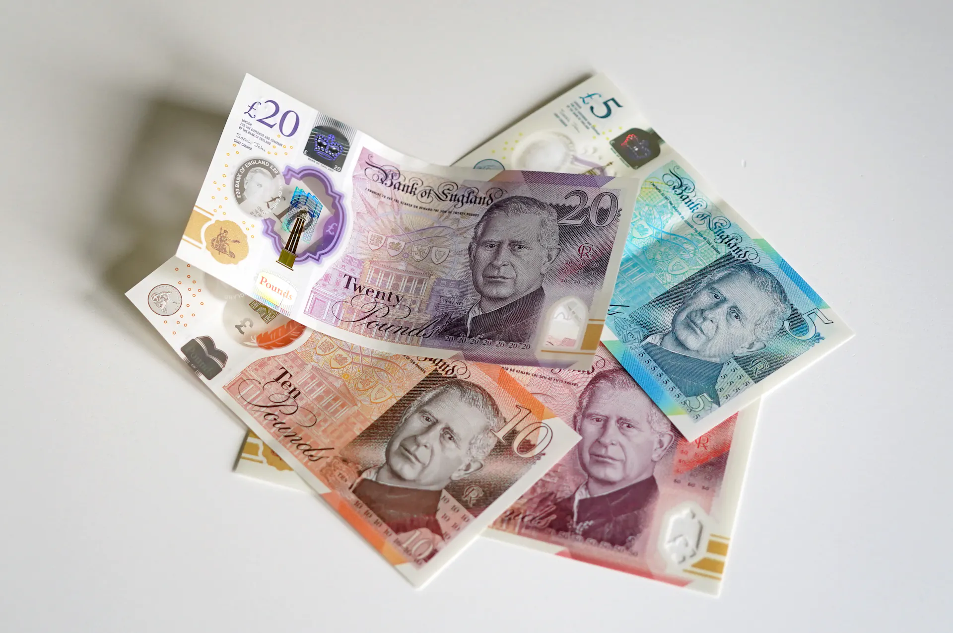 A view of bank notes &ndash; &pound;5, &pound;10, &pound;20 and &pound;50 &ndash; issued by the Bank of England, against a white backdrop