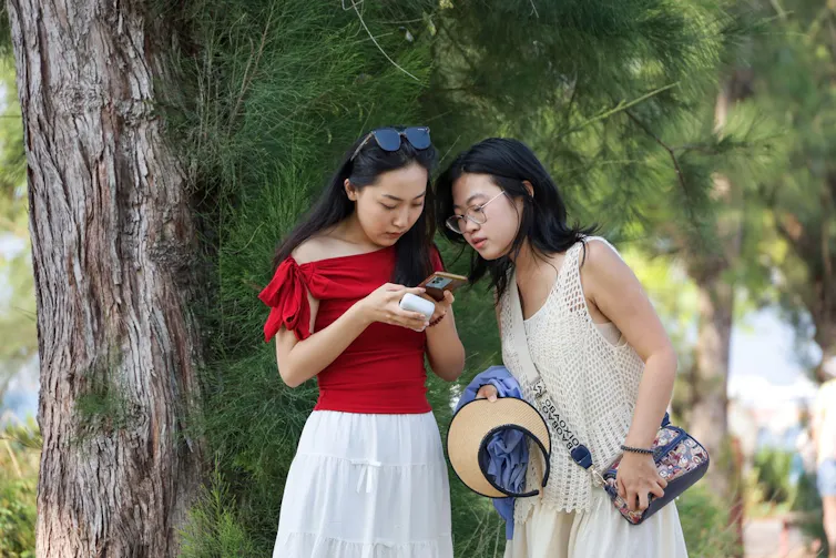 Two women looking at a phone