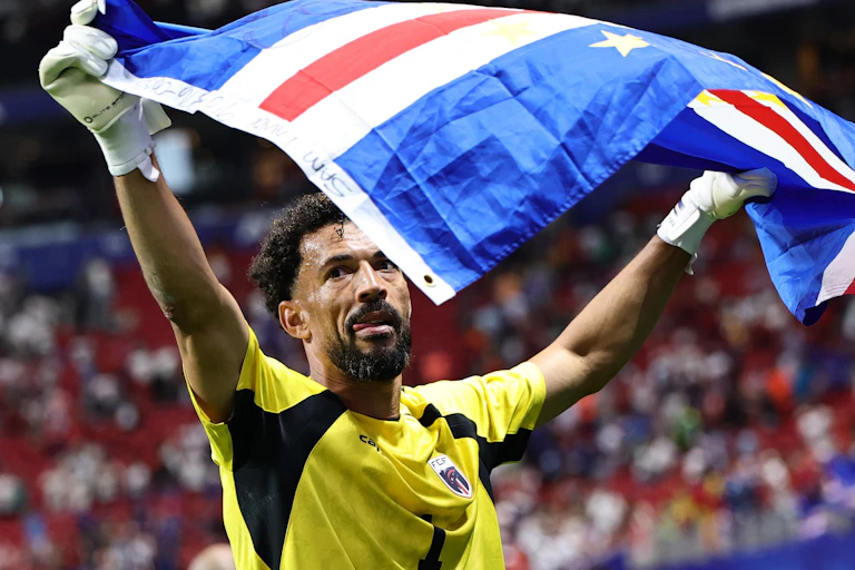 Cabo Verde goalkeeper Vozinha waves the national flag after the World Cup group stage match against Spain.
