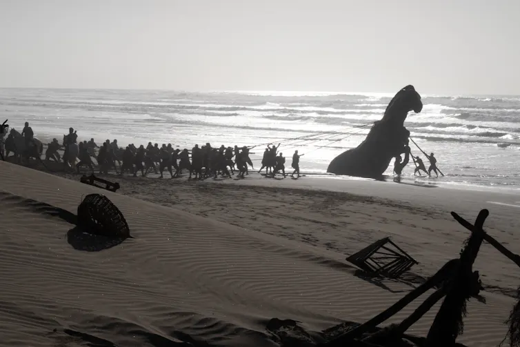 Film still: the horse of Troy being pulled out of the water.