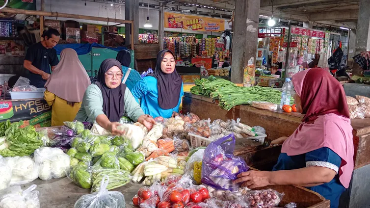 Women selling vegetables in an Indonesian market.