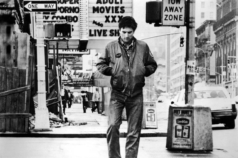 A black and white image of a solitary man walk down a New York street.