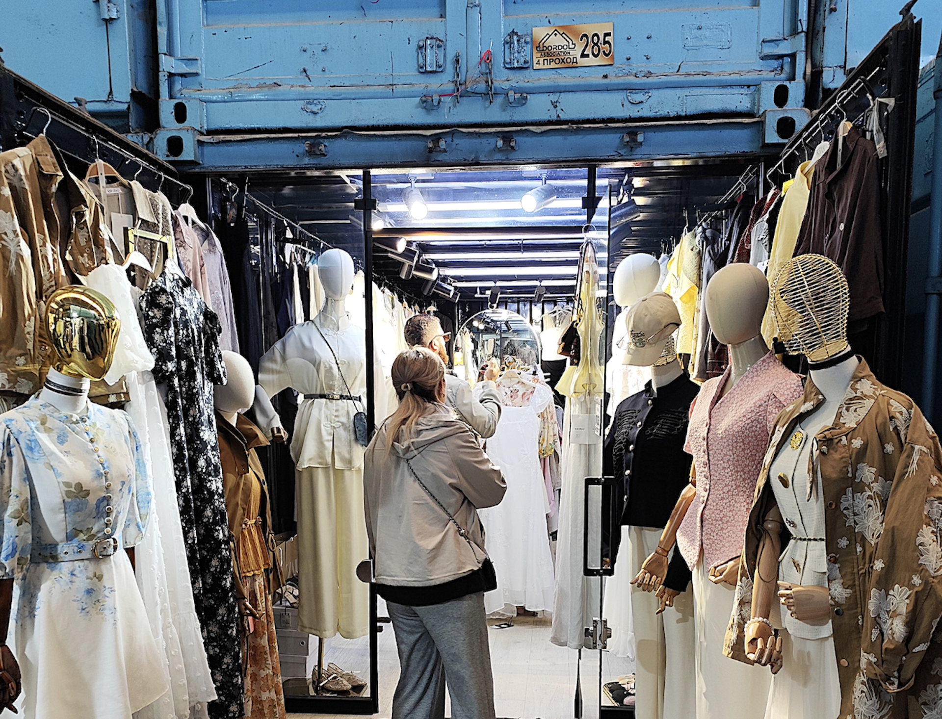 People shopping at clothes store on market