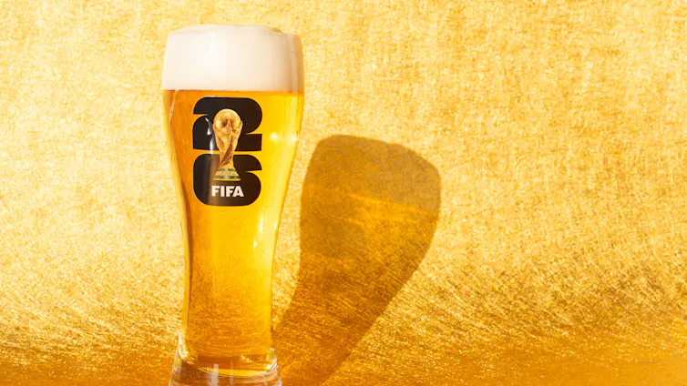 Beer in glass with World Cup logo.