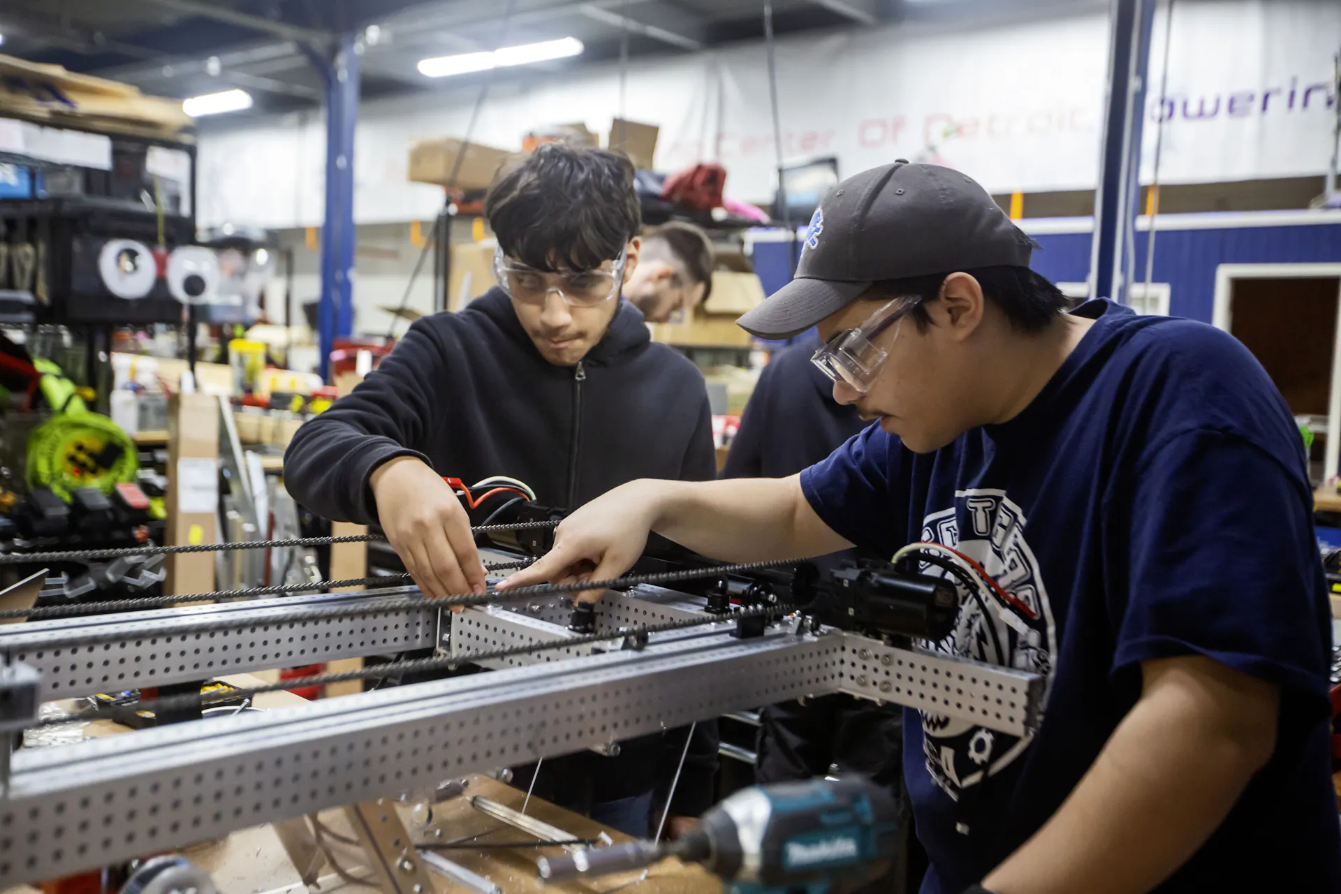 Two high school students work on robotics project.