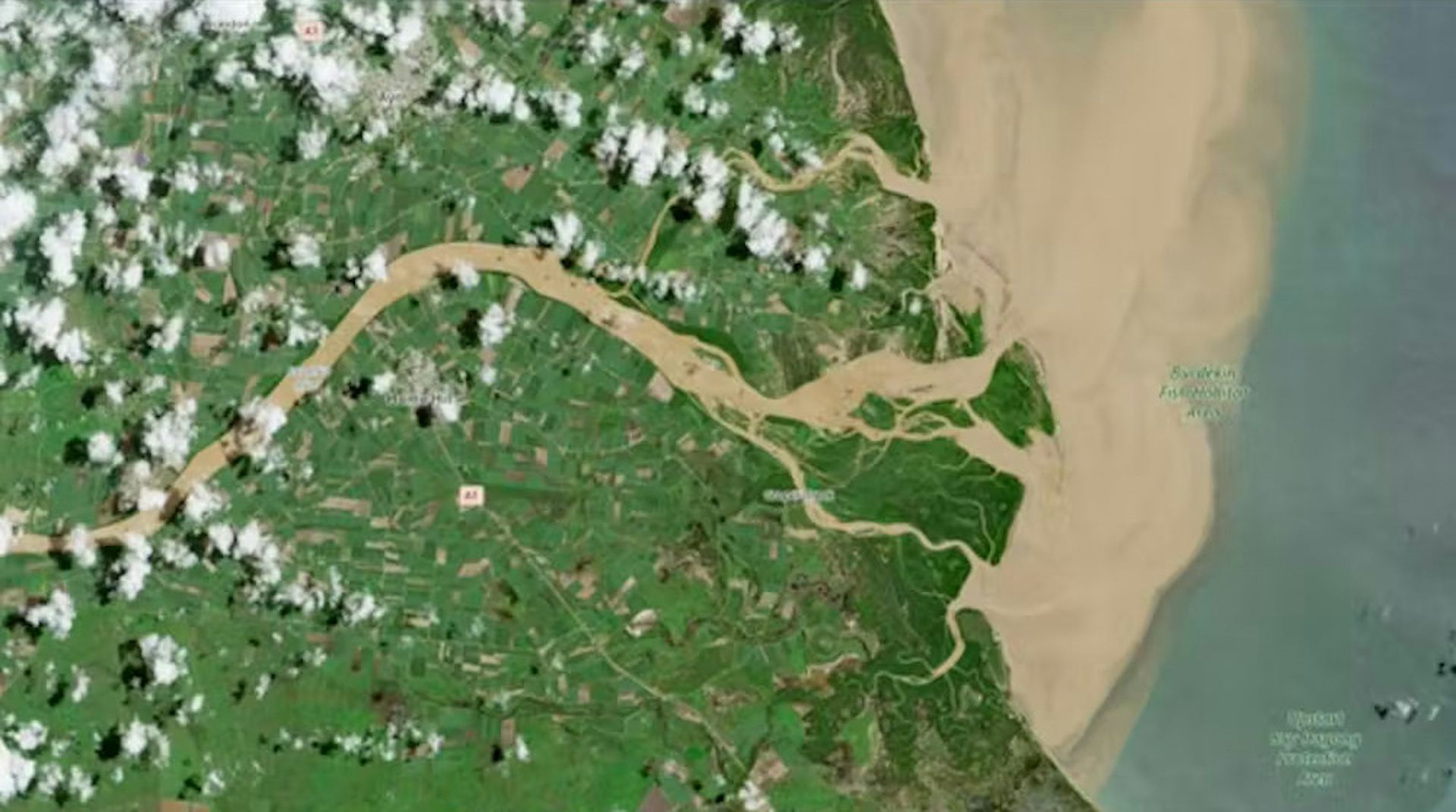 satellite image showing plume of floodwater going out into ocean.