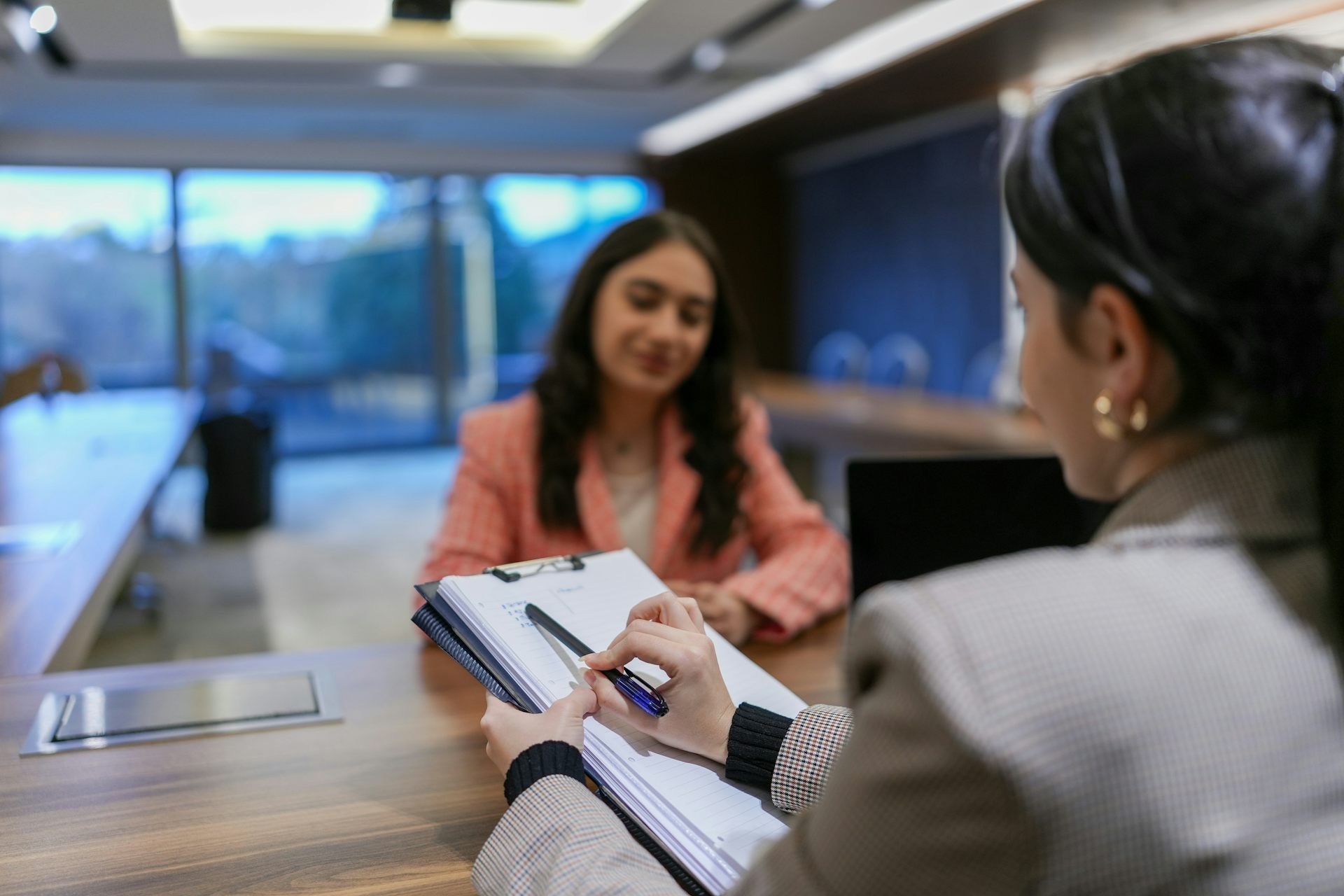 A woman interviews a young woman for a job