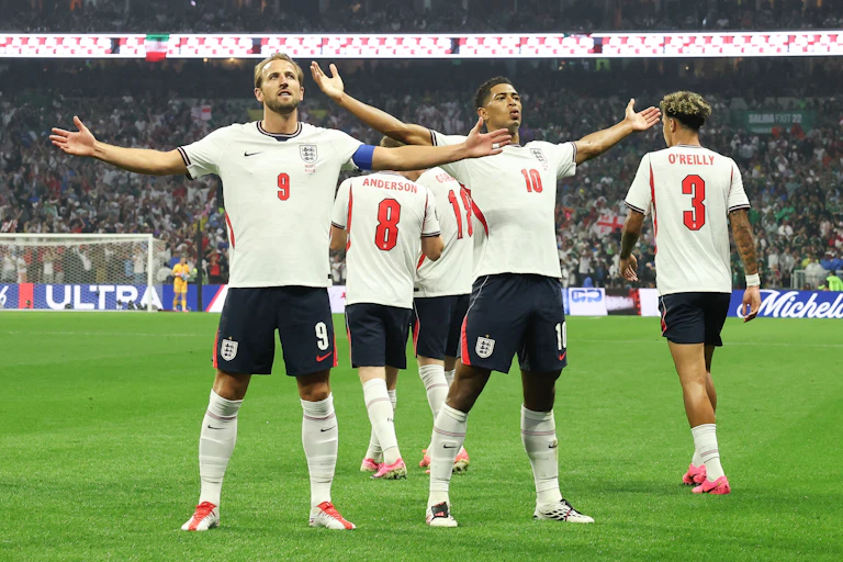 harry kane and jude bellingham acknowledge the crowd with their arms outstretched after england's win over mexico