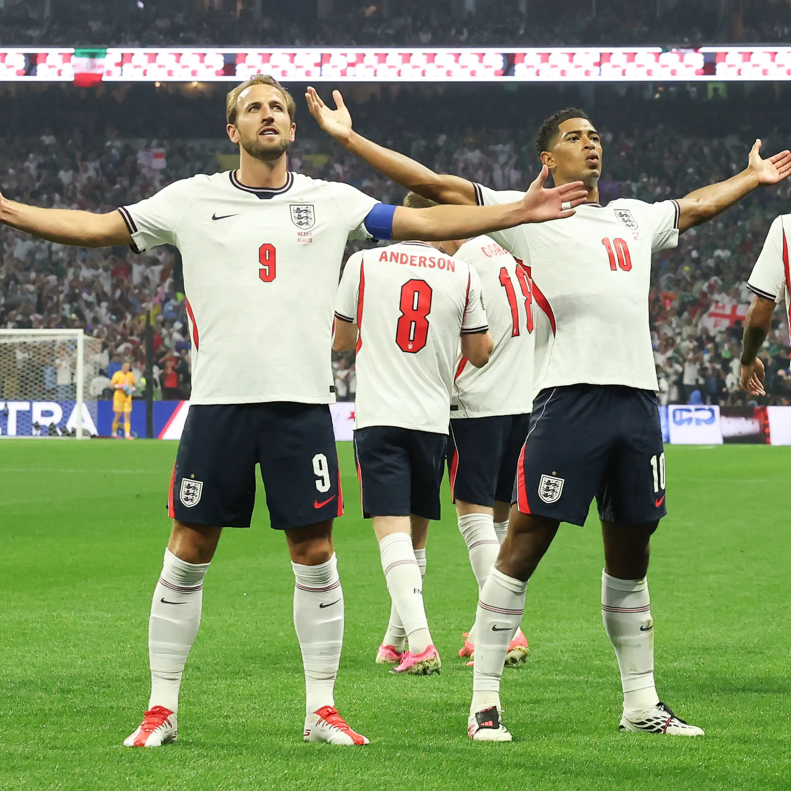 harry kane and jude bellingham acknowledge the crowd with their arms outstretched after england's win over mexico