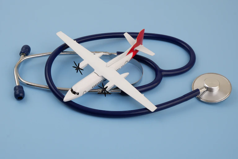 A photo of a toy airplane nestled among a coiled-up stethoscope.