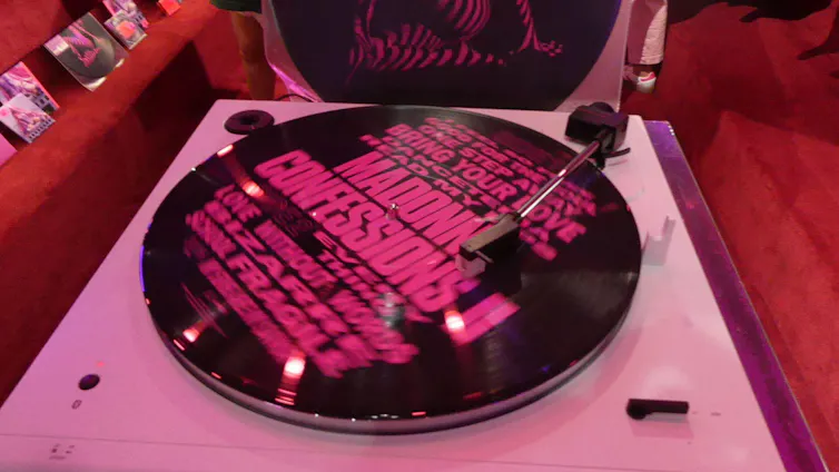 A pink and black record on a turntable.