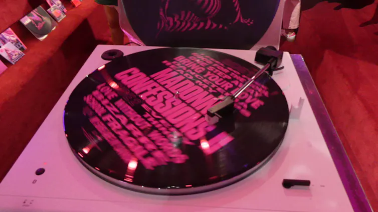 A pink and black record on a turntable.