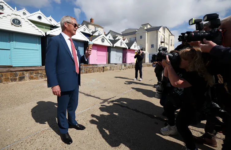 nigel farage faces the media while campaigning in clacton