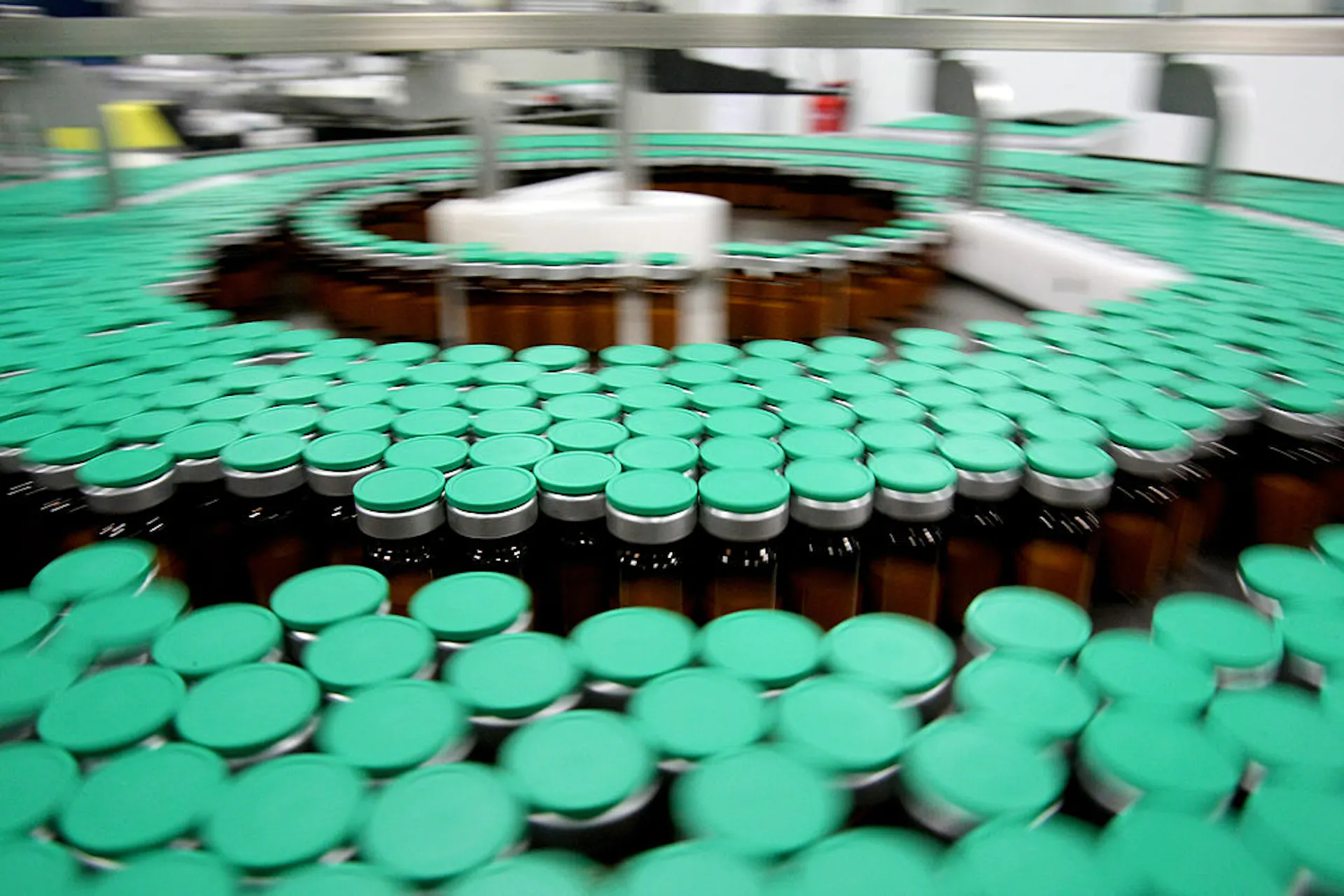 Large assortment of vials in three concentric circles on a manufacturing line