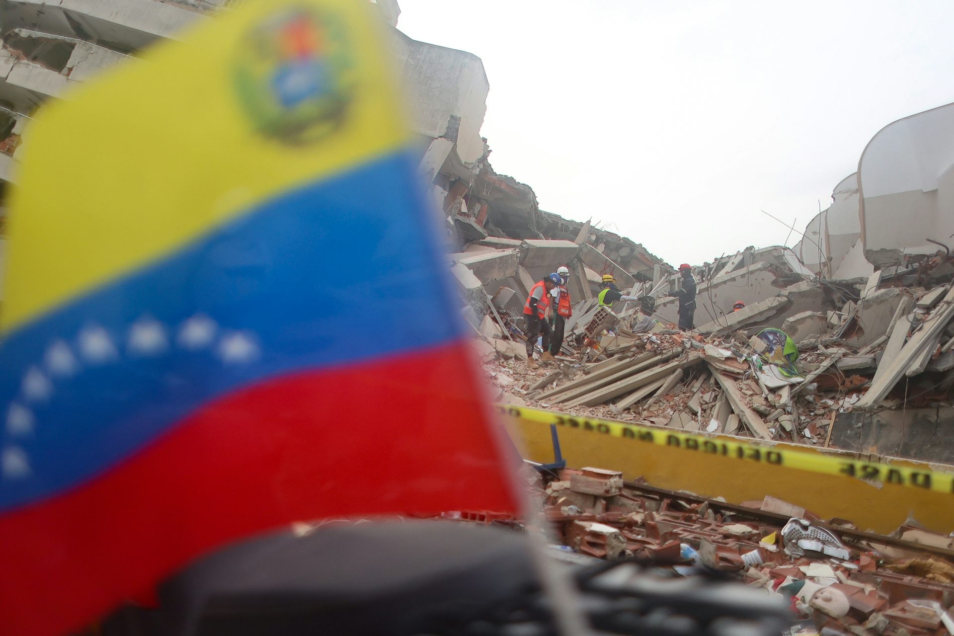 Volunteers take part in search and rescue efforts at a collapsed building in Caraballeda.