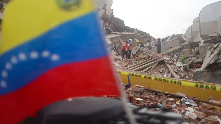Volunteers take part in search and rescue efforts at a collapsed building in Caraballeda.