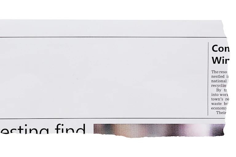Torn-out piece from a newspaper with blank space for an article, advertisement or picture.