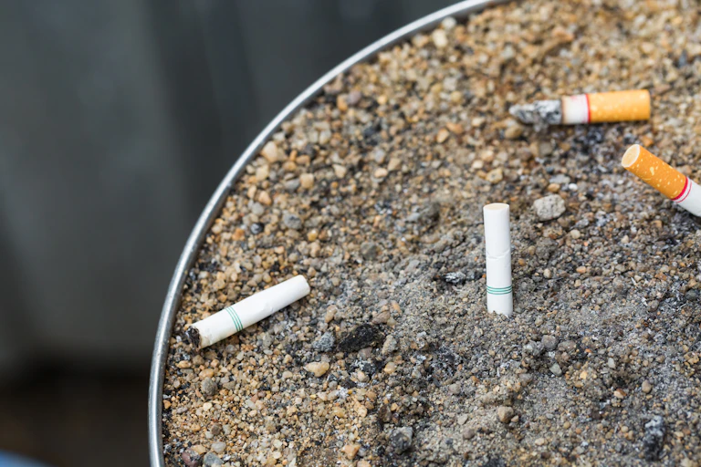 Outdoor ashtray with four cigarette buts