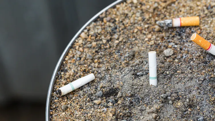 Outdoor ashtray with four cigarette buts