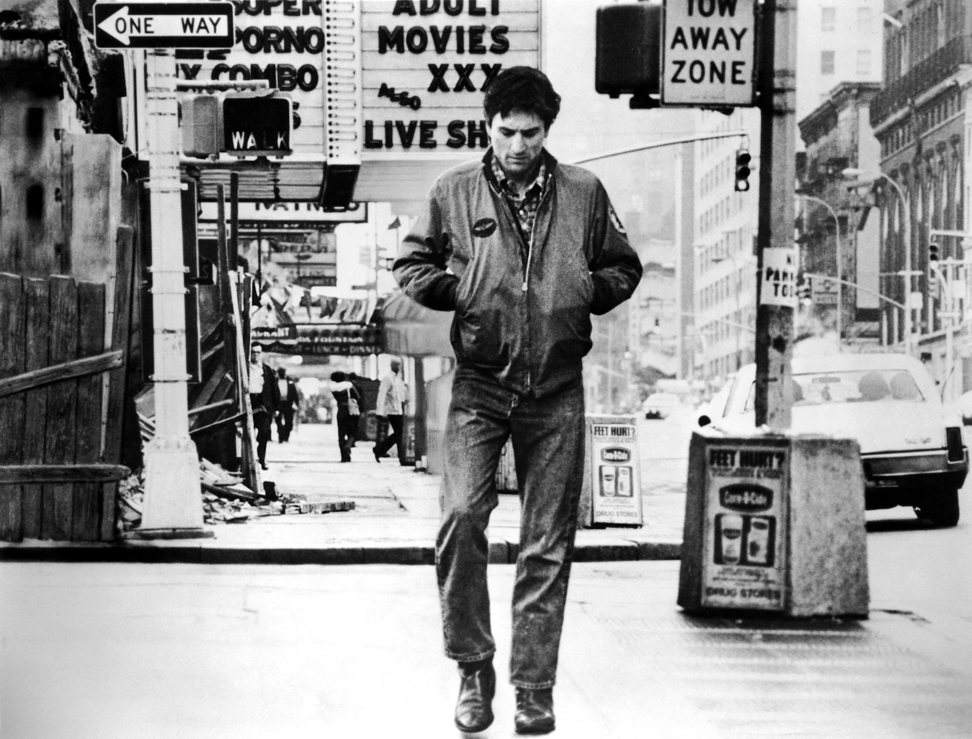 A black and white image of a solitary man walk down a New York street.